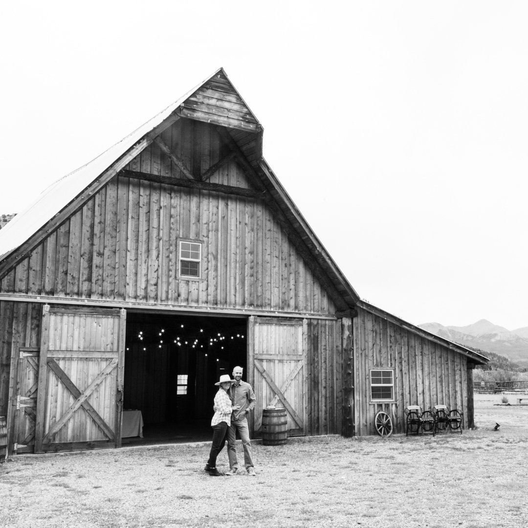Home - Our Story - Christina and David Outside the barn b&w