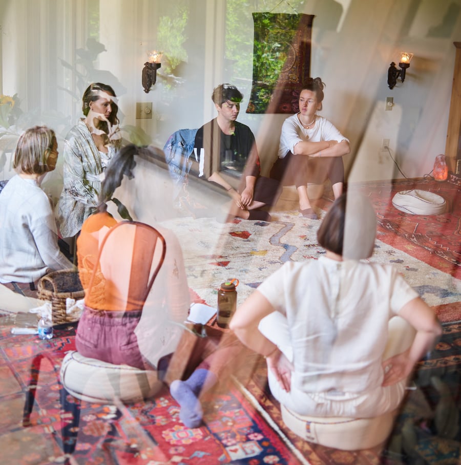 A group of people sitting around a group therapy